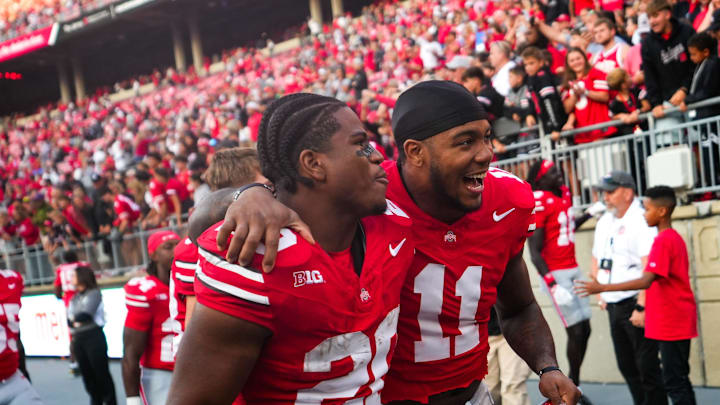 Ohio State Buckeyes running back James Peoples (20) and linebacker C.J. Hicks (11) celebrate after defeating Grambling State Tigers in the NCAA football game at the Ohio Stadium on Saturday, Sept. 6, 2025 in Columbus, Ohio.