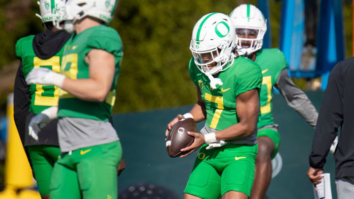 Oregon defensive back Jabbar Muhammad carries the ball during practice with the Ducks Tuesday, April 23, 2024 at the Hatfield-Dowlin Complex in Eugene, Ore.