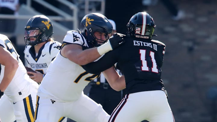 Nov 30, 2024; Lubbock, Texas, USA;  West Virginia Mountaineers offensive lineman Wyatt Milum (74) blocks Texas Tech Red Raiders defensive back Charles Esters III (11) in the first half at Jones AT&T Stadium and Cody Campbell Field. Mandatory Credit: Michael C. Johnson-Imagn Images