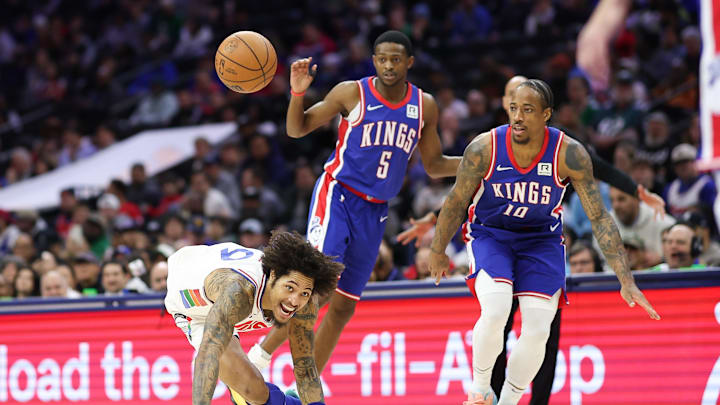 Jan 29, 2025; Philadelphia, Pennsylvania, USA; Philadelphia 76ers guard Kelly Oubre Jr. (9) looses control of the ball while dribbles against Sacramento Kings forward DeMar DeRozan (10) and guard De'Aaron Fox (5) during the third quarter at Wells Fargo Center. Mandatory Credit: Bill Streicher-Imagn Images