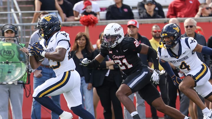 Nov 1, 2025; Houston, Texas, USA; West Virginia Mountaineers running back Cyncir Bowers (23) scores a touchdown against Houston Cougars defensive back Zelmar Vedder (21) in the first half at TDECU Stadium. Mandatory Credit: Thomas Shea-Imagn Images Nov 1, 2025; Houston, Texas, USA; West Virginia Mountaineers running back Cyncir Bowers (23) scores a touchdown against Houston Cougars defensive back Zelmar Vedder (21) in the first half at TDECU Stadium. Mandatory Credit: Thomas Shea-Imagn Images