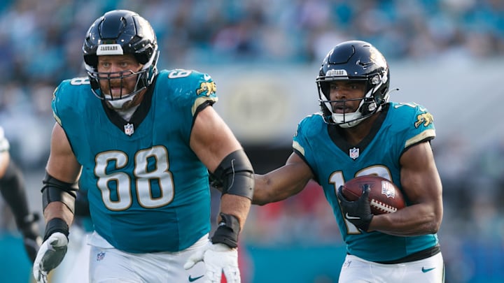 Dec 15, 2024; Jacksonville, Florida, USA; Jacksonville Jaguars offensive line Brandon Scherff (68) blocks for wide receiver Devin Duvernay (12) against the New York Jets during the fourth quarter at EverBank Stadium. Mandatory Credit: Morgan Tencza-Imagn Images