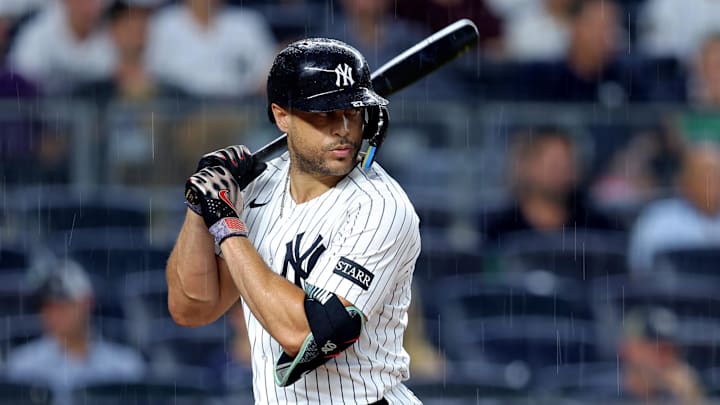 Jul 8, 2025; Bronx, New York, USA; New York Yankees designated hitter Giancarlo Stanton (27) bats in the rain during the fourth inning against the Seattle Mariners at Yankee Stadium. Mandatory Credit: Brad Penner-Imagn Images