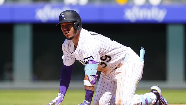 Aug 3, 2025; Denver, Colorado, USA; Colorado Rockies second baseman Thairo Estrada (39) doubles n the third inning against the Pittsburgh Pirates at Coors Field. Mandatory Credit: Ron Chenoy-Imagn Images