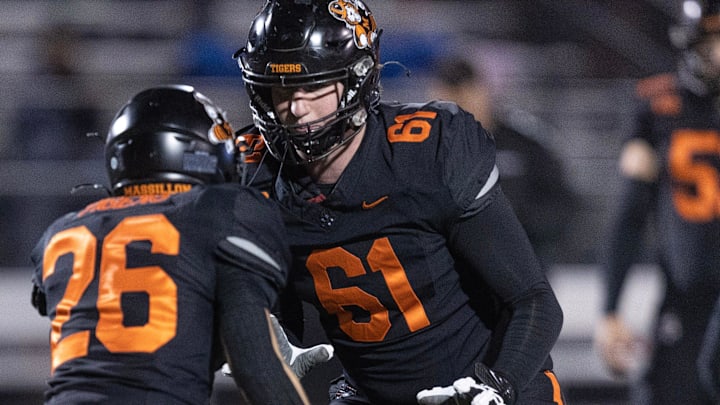 Massillon offensive tackle Nolan Davenport (61) gets loose ahead of a playoff game against Lake, Friday, Nov. 10, 2023.