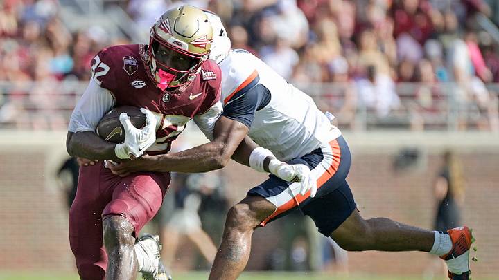 Oct 3, 2026; Tallahassee, Florida, USA;  Florida State Seminoles running back Ousmane Kromah (32) runs the ball against Virginia Cavaliers safety Brandyn Hillman (6) during the second half at Doak S. Campbell Stadium.  Mandatory Credit: Melina Myers-Imagn Images