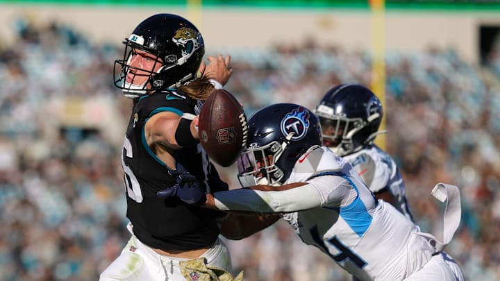 Nov 19, 2023; Jacksonville, Florida, USA;  Jacksonville Jaguars quarterback Trevor Lawrence (16) reaches into the end zone for a touchdown against the Tennessee Titans in the fourth quarter at EverBank Stadium. Mandatory Credit: Nathan Ray Seebeck-Imagn Images