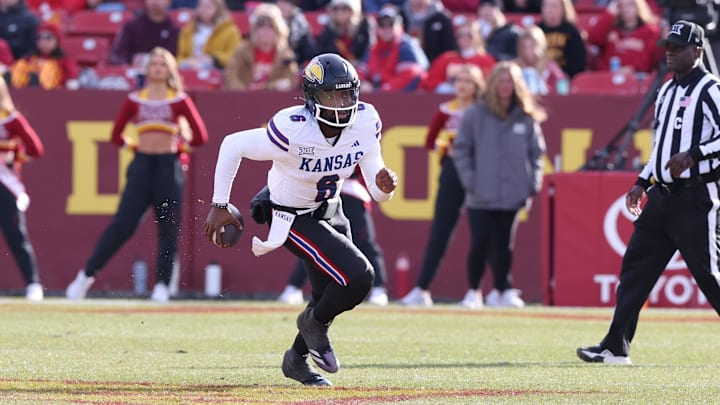 Nov 22, 2025; Ames, Iowa, USA; Kansas Jayhawks quarterback Jalon Daniels (6) runs the football against the Iowa State Cyclones during the second half at Jack Trice Stadium. Mandatory Credit: Reese Strickland-Imagn Images