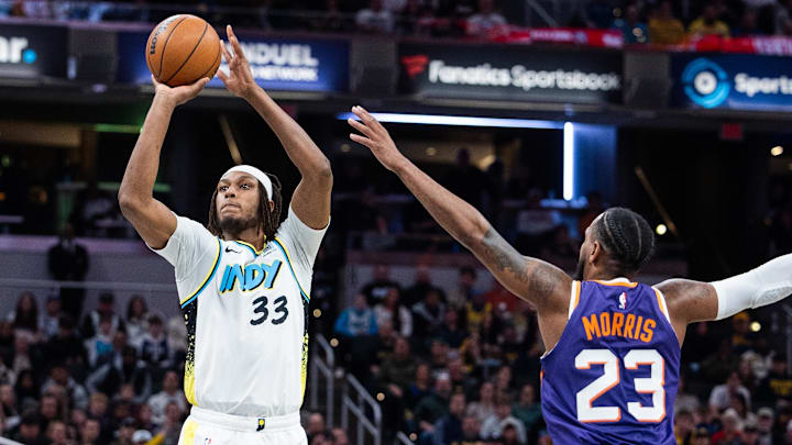 Jan 4, 2025; Indianapolis, Indiana, USA; Indiana Pacers center Myles Turner (33)  shoots the ball against Phoenix Suns guard Monte Morris (23) in the second half at Gainbridge Fieldhouse. Mandatory Credit: Trevor Ruszkowski-Imagn Images