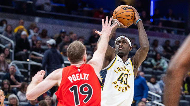 Feb 26, 2025; Indianapolis, Indiana, USA; Indiana Pacers forward Pascal Siakam (43) shoots the ball while Toronto Raptors center Jakob Poeltl (19) defends in the second half at Gainbridge Fieldhouse. Mandatory Credit: Trevor Ruszkowski-Imagn Images