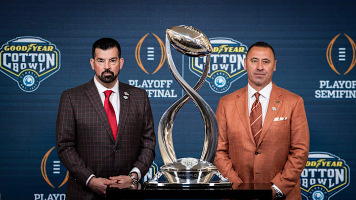 Ohio State Buckeyes Head Coach Ryan Day, left, and Texas Longhorns Head Coach Steve Sarkisian stand next to the trophy for a photo following the Coaches' Press Conference at AT&T Stadium, Jan. 9, 2024. Both coaches answered questions from the media during the conference, and will face each other in the Cotton Bowl College Football Playoff semi-final game on Friday.