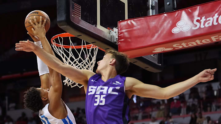 Jul 13, 2022; Las Vegas, NV, USA; Oklahoma City Thunder guard Aaron Wiggins (21) dunks as Sacramento Kings guard Alex O'Connell (35) defends during an NBA Summer League game at Thomas & Mack Center. Mandatory Credit: Stephen R. Sylvanie-Imagn Images