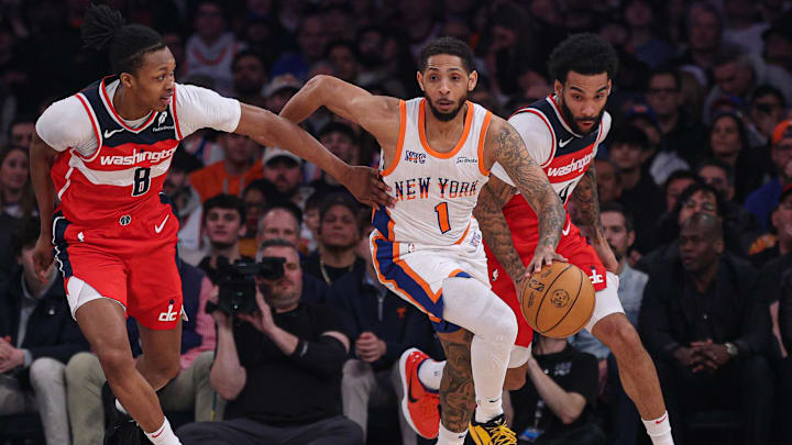 Mar 22, 2025; New York, New York, USA; New York Knicks guard Cameron Payne (1) dribbles up court in front of Washington Wizards guard Bub Carrington (8) and forward Justin Champagnie (9) during the first quarter at Madison Square Garden. Mandatory Credit: Vincent Carchietta-Imagn Images