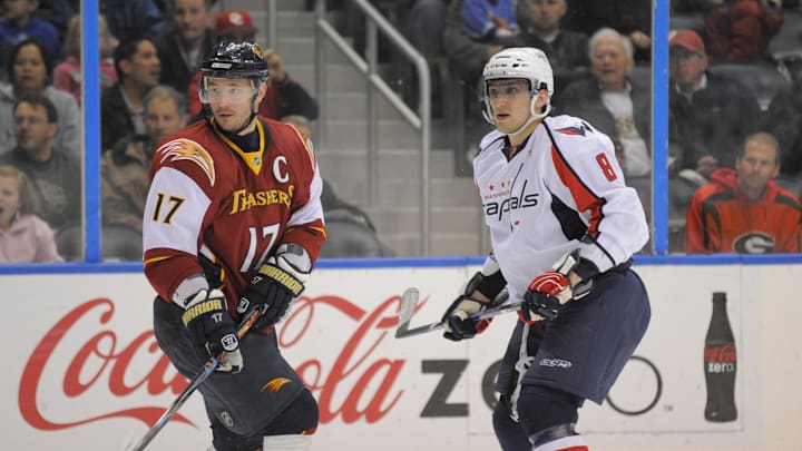 Apr 7, 2009; Atlanta, GA, USA; Atlanta Thrashers left wing Ilya Kovalchuk (17) and Washington Capitals left wing Alex Ovechkin (8) follow the flight of Ovechkin's shot at the net in the third period at Philips Arena. The Capitals defeated the Thrashers 4-2. 