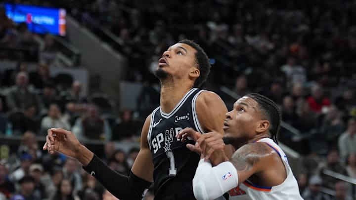 Dec 31, 2025; San Antonio, Texas, USA;  San Antonio Spurs forward Victor Wembanyama (1) blocks out New York Knicks guard Miles McBride (2) in the first half at Frost Bank Center. Mandatory Credit: Daniel Dunn-Imagn Images
