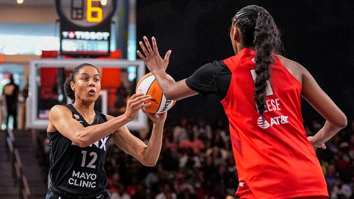 Aug 30, 2026; College Park, Georgia, USA; Minnesota Lynx forward Nia Coffey (12) looks to pass against Atlanta Dream forward Angel Reese (5) at Gateway Center Arena at College Park. Mandatory Credit: Dale Zanine-Imagn Images