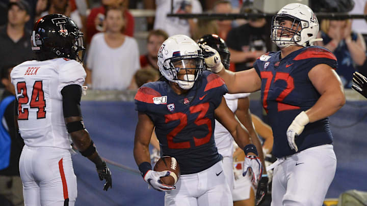 Sep 14, 2019; Tucson, AZ, USA; Arizona Wildcats running back Gary Brightwell (23) and offensive lineman Edgar Burrola (72) celebrate during the second half against the Texas Tech Red Raiders at Arizona Stadium. Mandatory Credit: Casey Sapio-Imagn Images