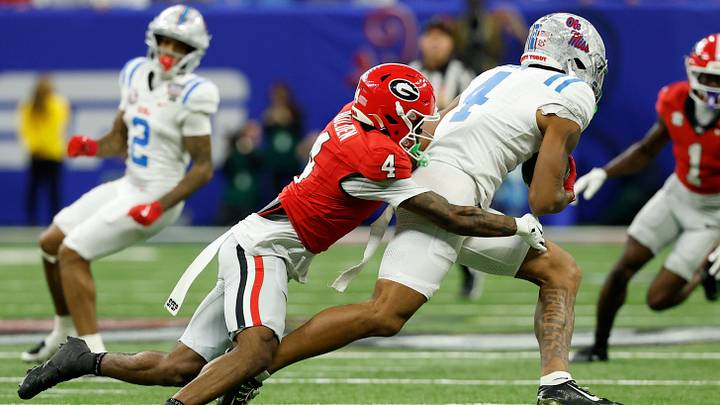 Jan 1, 2026; New Orleans, LA, USA; Mississippi Rebels wide receiver Caleb Odom (4) Mississippi Rebels linebacker Suntarine Perkins (4) is tackled after catching a pass by Georgia Bulldogs defensive back Kj Bolden (4) during the first half in the 2026 Sugar Bowl and quarterfinal game of the College Football Playoff at Caesars Superdome. Mandatory Credit: Geoff Burke-Imagn Images Jan 1, 2026; New Orleans, LA, USA; Mississippi Rebels wide receiver Caleb Odom (4) Mississippi Rebels linebacker Suntarine Perkins (4) is tackled after catching a pass by Georgia Bulldogs defensive back Kj Bolden (4) during the first half in the 2026 Sugar Bowl and quarterfinal game of the College Football Playoff at Caesars Superdome. Mandatory Credit: Geoff Burke-Imagn Images