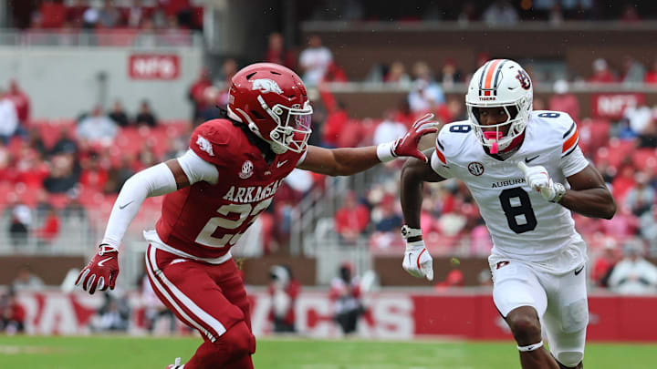 Oct 25, 2025; Fayetteville, Arkansas, USA; Auburn Tigers wide receiver Cam Coleman (8) runs a route resulting in a touchdown catch as Arkansas Razorbacks defensive back Julian Neal (23) defends during the first quarter at Donald W. Reynolds Razorback Stadium. Mandatory Credit: Nelson Chenault-Imagn Images