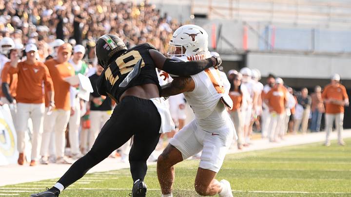 Oct 26, 2024; Nashville, Tennessee, USA; Vanderbilt Commodores safety Jalen Gilbert (18) drags Texas Longhorns wide receiver DeAndre Moore Jr. (0) down just before the goal line during the first half at FirstBank Stadium. Mandatory Credit: Steve Roberts-Imagn Images Oct 26, 2024; Nashville, Tennessee, USA; Vanderbilt Commodores safety Jalen Gilbert (18) drags Texas Longhorns wide receiver DeAndre Moore Jr. (0) down just before the goal line during the first half at FirstBank Stadium. Mandatory Credit: Steve Roberts-Imagn Images