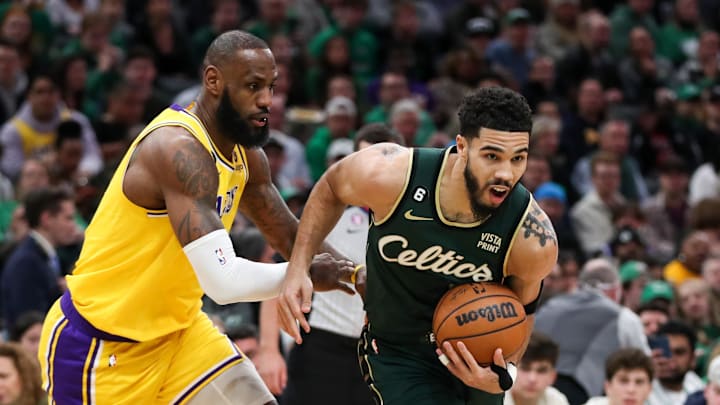 Jan 28, 2023; Boston, Massachusetts, USA; Boston Celtics forward Jayson Tatum (0) defended by Los Angeles Lakers forward LeBron James (6) during the first half at TD Garden. Mandatory Credit: Paul Rutherford-Imagn Images