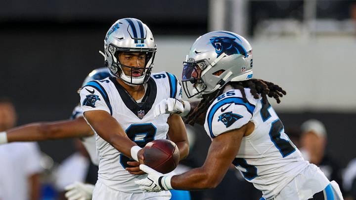 Carolina Panthers quarterback Bryce Young (9) hands off to running back Jonathon Brooks 