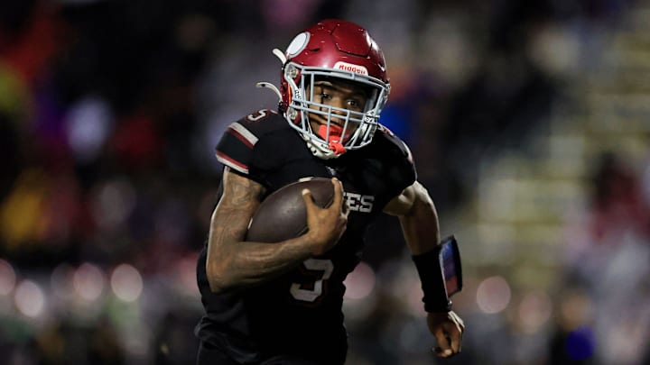 Raines' Tadarius Washington (5) scores a rushing touchdown during the third quarter of a Class 3A semifinal against Sarasota Booker on Dec. 5, 2025. Raines won that game, 28-8, and went on to beat Miami Northwestern, 23-22, for the title on a TD catch by Washington with 10 seconds left at FIU in Miami on Dec. 12, 2025.