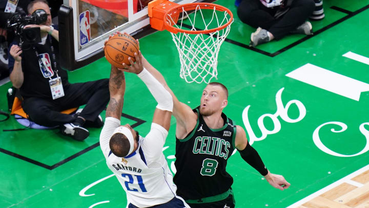 Jun 9, 2024; Boston, Massachusetts, USA; Boston Celtics center Kristaps Porzingis (8) blocks Dallas Mavericks center Daniel Gafford (21) 