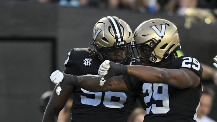 Aug 30, 2025; Nashville, Tennessee, USA;  Vanderbilt Commodores edge rusher Miles Caper celebrates the tackle for loss with linebacker Nick Rinaldi (24) and defensive lineman Khordae Sydnor (96) during the first half at FirstBank Stadium. 