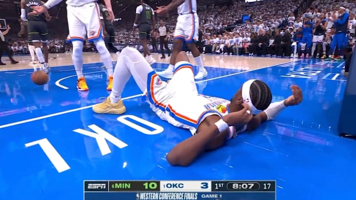 Shai Gilgeous-Alexander lays on the ground after Anthony Edwards threw the ball at him on May 20, 2025.
