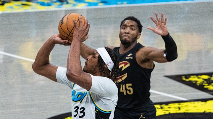 May 9, 2025; Indianapolis, Indiana, USA; Indiana Pacers center Myles Turner (33) shoots the ball while Cleveland Cavaliers guard Donovan Mitchell (45) defends during game three of the second round for the 2025 NBA Playoffs at Gainbridge Fieldhouse. Mandatory Credit: Trevor Ruszkowski-Imagn Images