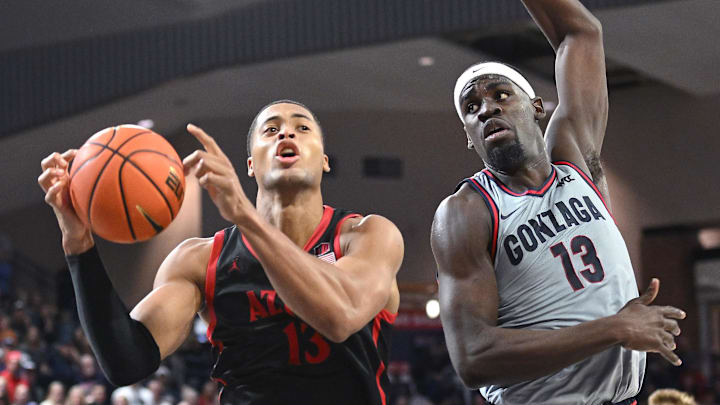 Dec 29, 2023; Spokane, Washington, USA; San Diego State Aztecs forward Jaedon LeDee (13) shoots the ball against Gonzaga Bulldogs forward Graham Ike (13) in the second half at McCarthey Athletic Center. Mandatory Credit: James Snook-USA TODAY Sports