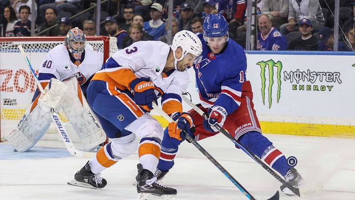 Oct 6, 2026; New York, New York, USA;  New York Islanders defenseman Adam Pelech (3) and New York Rangers left wing Alexis Lafreniere (13) battle for control of the puck in the third period at Madison Square Garden.  Mandatory Credit: Wendell Cruz-Imagn Images