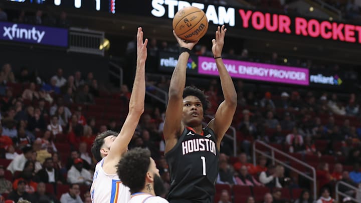 Jan 15, 2026; Houston, Texas, USA; Houston Rockets guard Amen Thompson (1) shoots the ball as Oklahoma City Thunder center Chet Holmgren (7) defends during the second quarter at Toyota Center. Mandatory Credit: Troy Taormina-Imagn Images