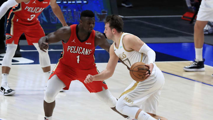 Feb 12, 2021; Dallas, Texas, USA;  Dallas Mavericks guard Luka Doncic (77) drives to the basket as New Orleans Pelicans forward Zion Williamson (1) defends during the second half at American Airlines Center. Mandatory Credit: Kevin Jairaj-Imagn Images