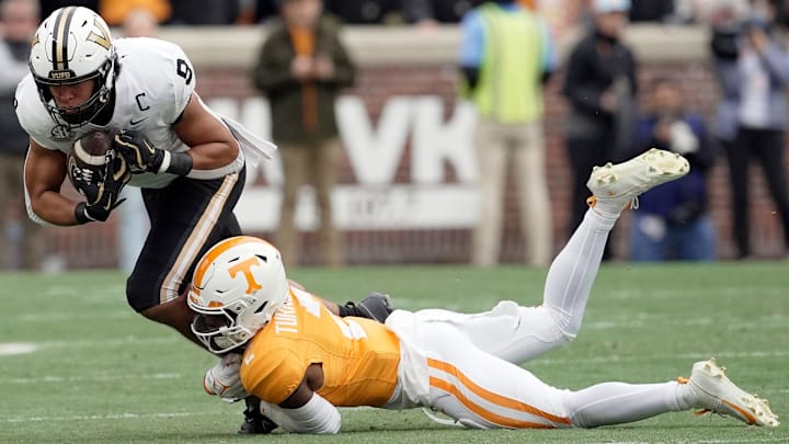 Vanderbilt tight end Eli Stowers (9) makes a catch as he is brought down by Tennessee defensive back Andre Turrentine (2) during the first quarter at Neyland Stadium in Knoxville, Tenn., Saturday, Nov. 29, 2025.