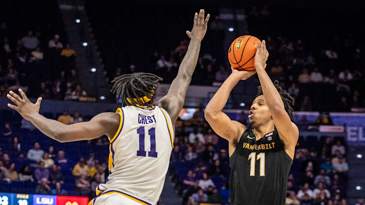 Jan 4, 2025; Baton Rouge, Louisiana, USA;  Vanderbilt Commodores guard AJ Hoggard (right) shoots a jump shot against LSU Tigers forward Corey Chest (11) during the second half at Pete Maravich Assembly Center.