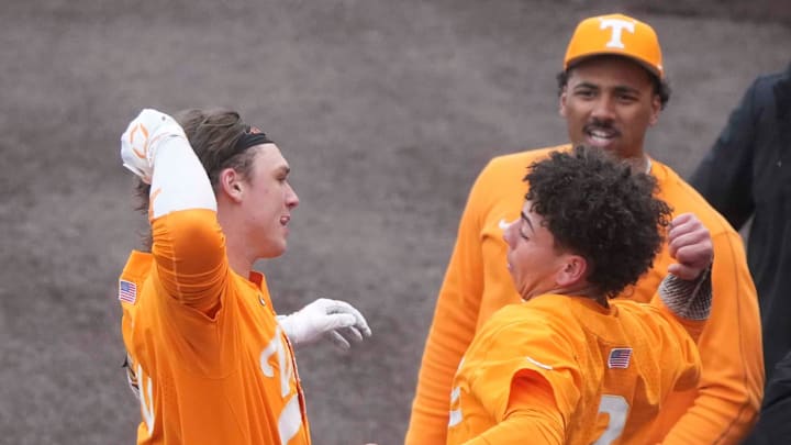Tennessee catcher/infielder Levi Clark (30) celebrates his grand slam with Tennessee infielder Ariel Antigua (2) at a Tennessee baseball game against Samford, in Lindsey Nelson Stadium at University of Tennessee in Knoxville, Tenn., Saturday, Feb. 22, 2025.
