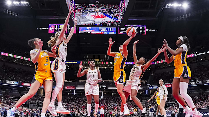 Jun 26, 2025; Indianapolis, Indiana, USA; Los Angeles Sparks guard Kelsey Plum (10) goes up for a basket against Indiana Fever guard Kelsey Mitchell (0) in the second half at Gainbridge Fieldhouse. Mandatory Credit: Grace Smith/INDIANAPOLIS STAR-Imagn Images Jun 26, 2025; Indianapolis, Indiana, USA; Los Angeles Sparks guard Kelsey Plum (10) goes up for a basket against Indiana Fever guard Kelsey Mitchell (0) in the second half at Gainbridge Fieldhouse. Mandatory Credit: Grace Smith/INDIANAPOLIS STAR-Imagn Images