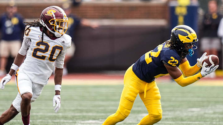 Michigan defensive back Elijah Dotson (22) intercepts a pass intended for Central Michigan wide receiver Langston Lewis (20) during the second half at Michigan Stadium in Ann Arbor on Saturday, Sept. 13, 2025.