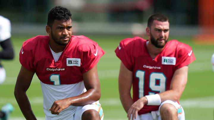 Aug 2, 2022; Miami Gardens, Florida, US; Miami Dolphins quarterback Tua Tagovailoa (1) and quarterback Skylar Thompson (19) stretch during training camp at Baptist Health Training Complex. Mandatory Credit: Jasen Vinlove-Imagn Images