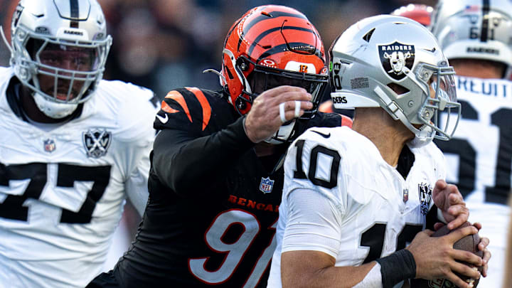 Cincinnati Bengals defensive end Trey Hendrickson (91) strips Las Vegas Raiders quarterback Desmond Ridder (10) of the ball in the fourth quarter of the NFL game at Paycor Stadium in Cincinnati on Sunday, Nov. 3, 2024.