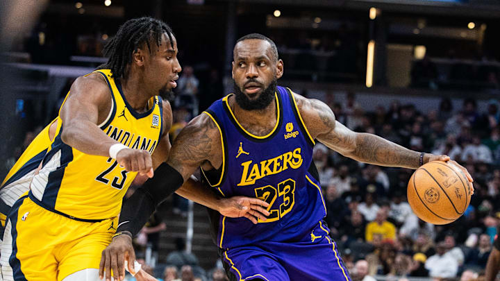 Mar 29, 2024; Indianapolis, Indiana, USA; Los Angeles Lakers forward LeBron James (23) dribbles the ball while Indiana Pacers forward Aaron Nesmith (23) defends in the second half at Gainbridge Fieldhouse. Mandatory Credit: Trevor Ruszkowski-Imagn Images Mar 29, 2024; Indianapolis, Indiana, USA; Los Angeles Lakers forward LeBron James (23) dribbles the ball while Indiana Pacers forward Aaron Nesmith (23) defends in the second half at Gainbridge Fieldhouse. Mandatory Credit: Trevor Ruszkowski-Imagn Images