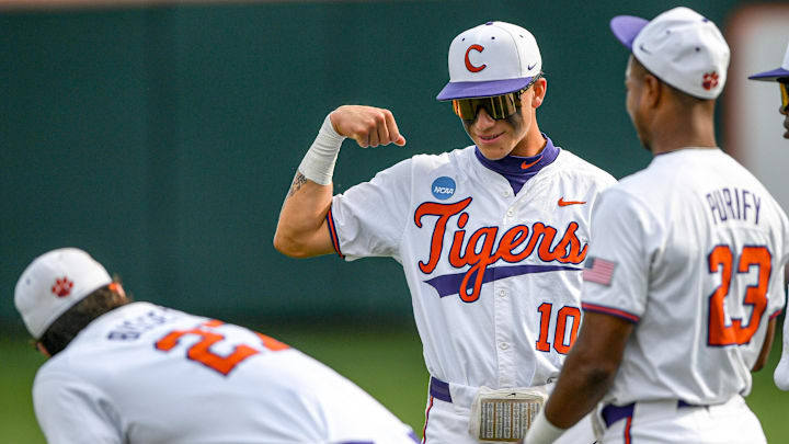 Jun 2, 2024; Clemson, South Carolina, USA; Clemson sophomore Cam Cannarella (10) flexes near sophomore Tristan Bissetta (27) with a smile before the game with Clemson and Coastal Carolina University the NCAA baseball Clemson Regional at Doug Kingsmore Stadium in Clemson.