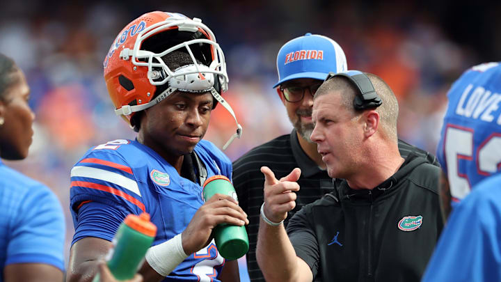 Sep 6, 2025; Gainesville, Florida, USA; Florida Gators head coach Billy Napier talks with Florida Gators quarterback DJ Lagway (2) against the South Florida Bulls during the first quarter at Ben Hill Griffin Stadium. Mandatory Credit: Kim Klement Neitzel-Imagn Images
