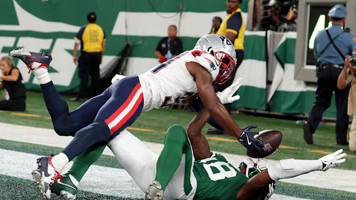 Sep 19, 2024; East Rutherford, New Jersey, USA; New England Patriots cornerback Jonathan Jones (31) breaks up a pass intended for New York Jets wide receiver Mike Williams (18) during the fourth quarter at MetLife Stadium. Mandatory Credit: Brad Penner-Imagn Images