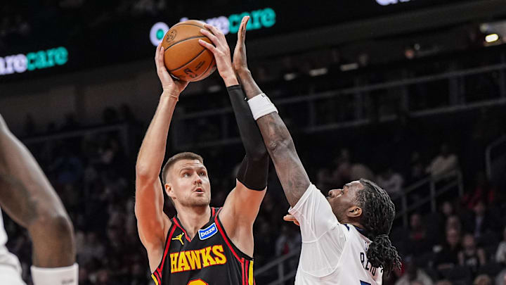Dec 31, 2025; Atlanta, Georgia, USA; Atlanta Hawks center Kristaps Porzingis (8) shoots over Minnesota Timberwolves center Naz Reid (11) during the first half at State Farm Arena. Mandatory Credit: Dale Zanine-Imagn Images