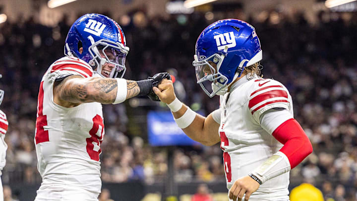 Oct 5, 2025; New Orleans, Louisiana, USA;  New York Giants tight end Theo Johnson (84) and quarterback Jaxson Dart (6) react to a touchdown against New Orleans Saints during the first half at Caesars Superdome.  