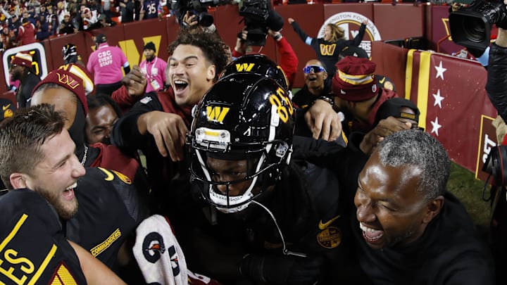 Teammates mob Brown after he catches a game-winning Hail Mary