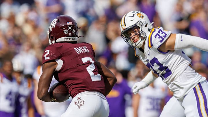 Nov 25, 2023; Baton Rouge, Louisiana, USA;  LSU Tigers linebacker West Weeks (33) chases down Texas A&M Aggies running back Rueben Owens (2) for a tackle during the first half at Tiger Stadium. Mandatory Credit: Stephen Lew-Imagn Images